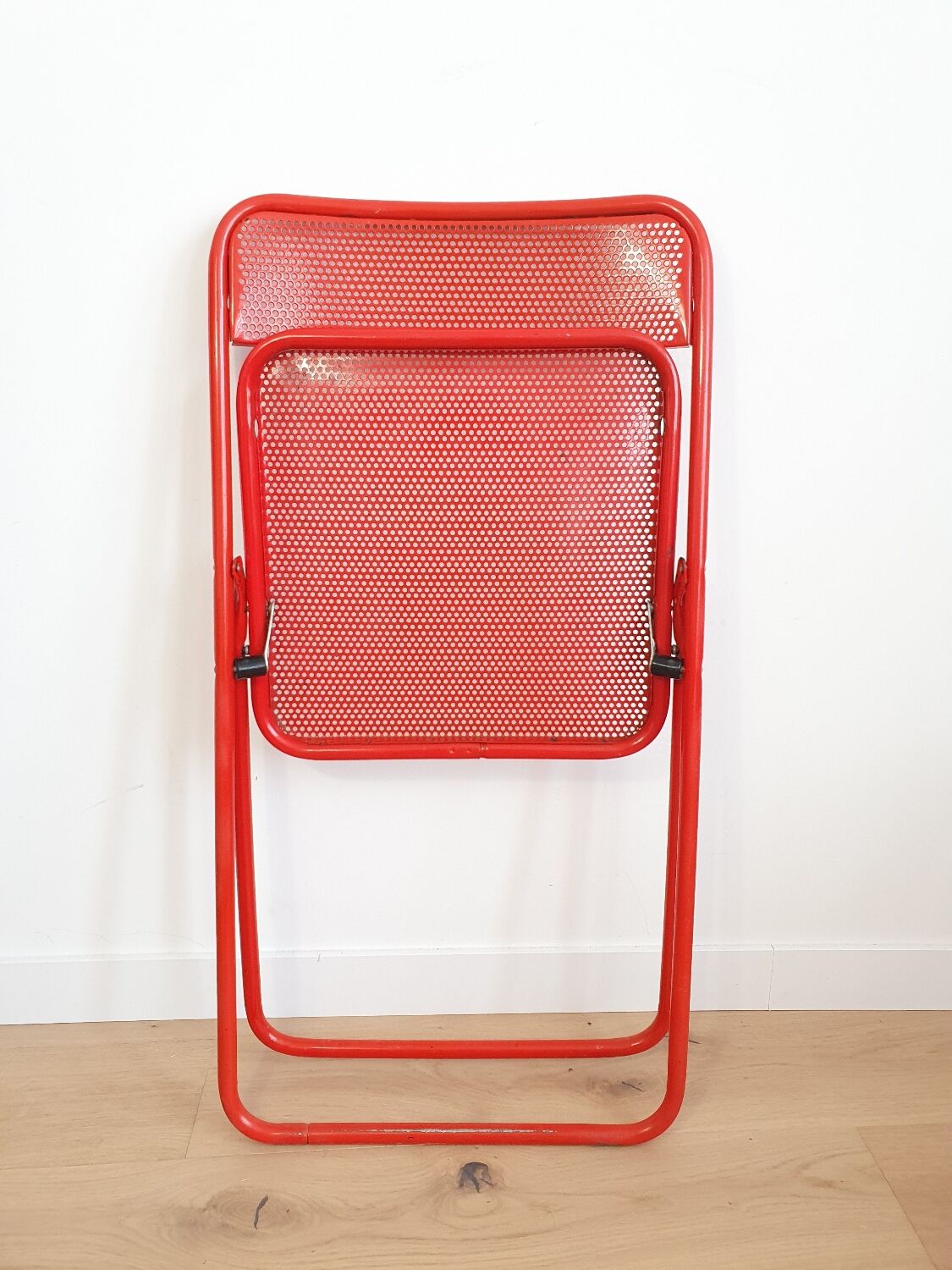 Perforated metal folding chair