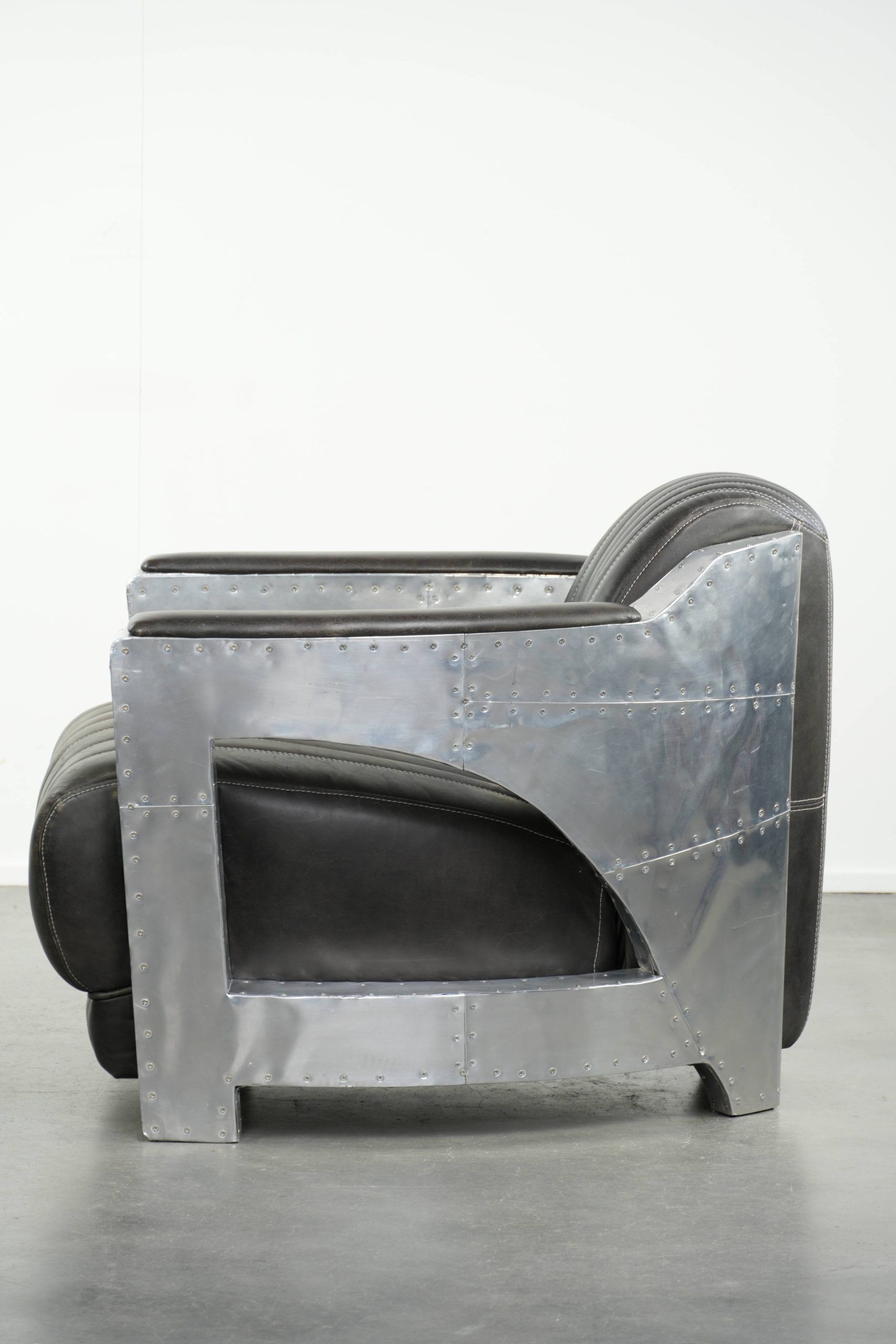 Cow leather aviator design armchair finished with aluminium and rivets