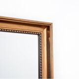 Mirror in a gold frame.