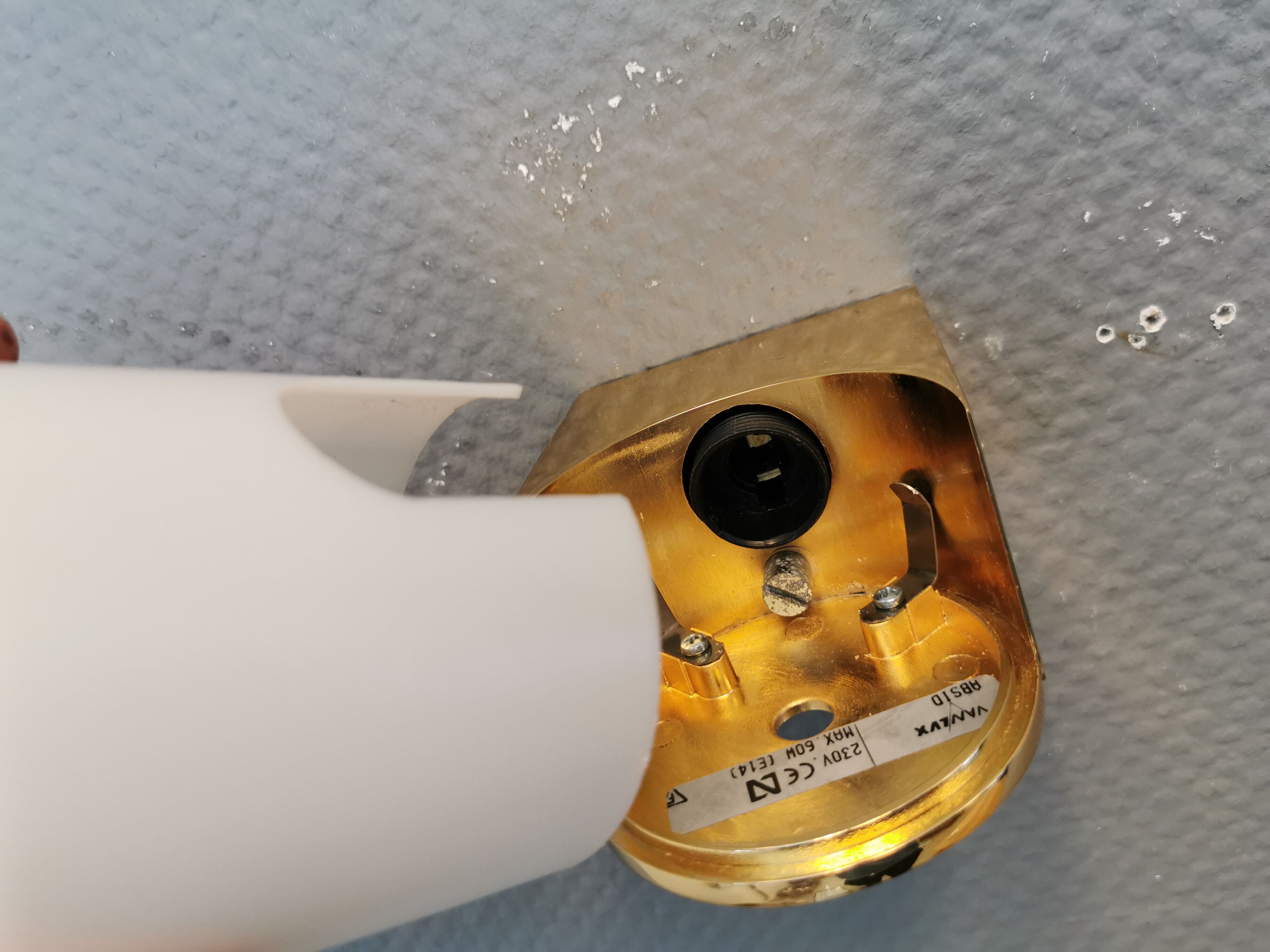 Wall lamps with milky white acrylic plastic shades and solid brass bases
