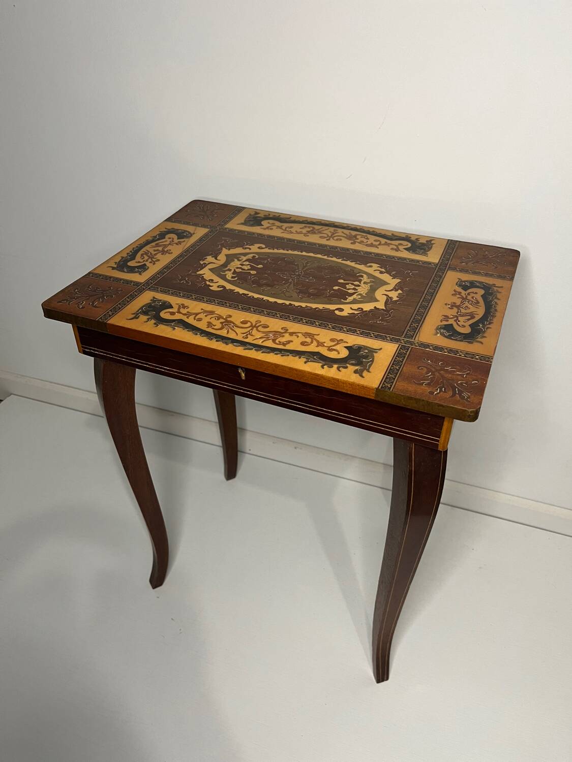 Small antique Italian inlaid table with Swiss music box.