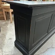 Immense bar counter covered with blue stone.