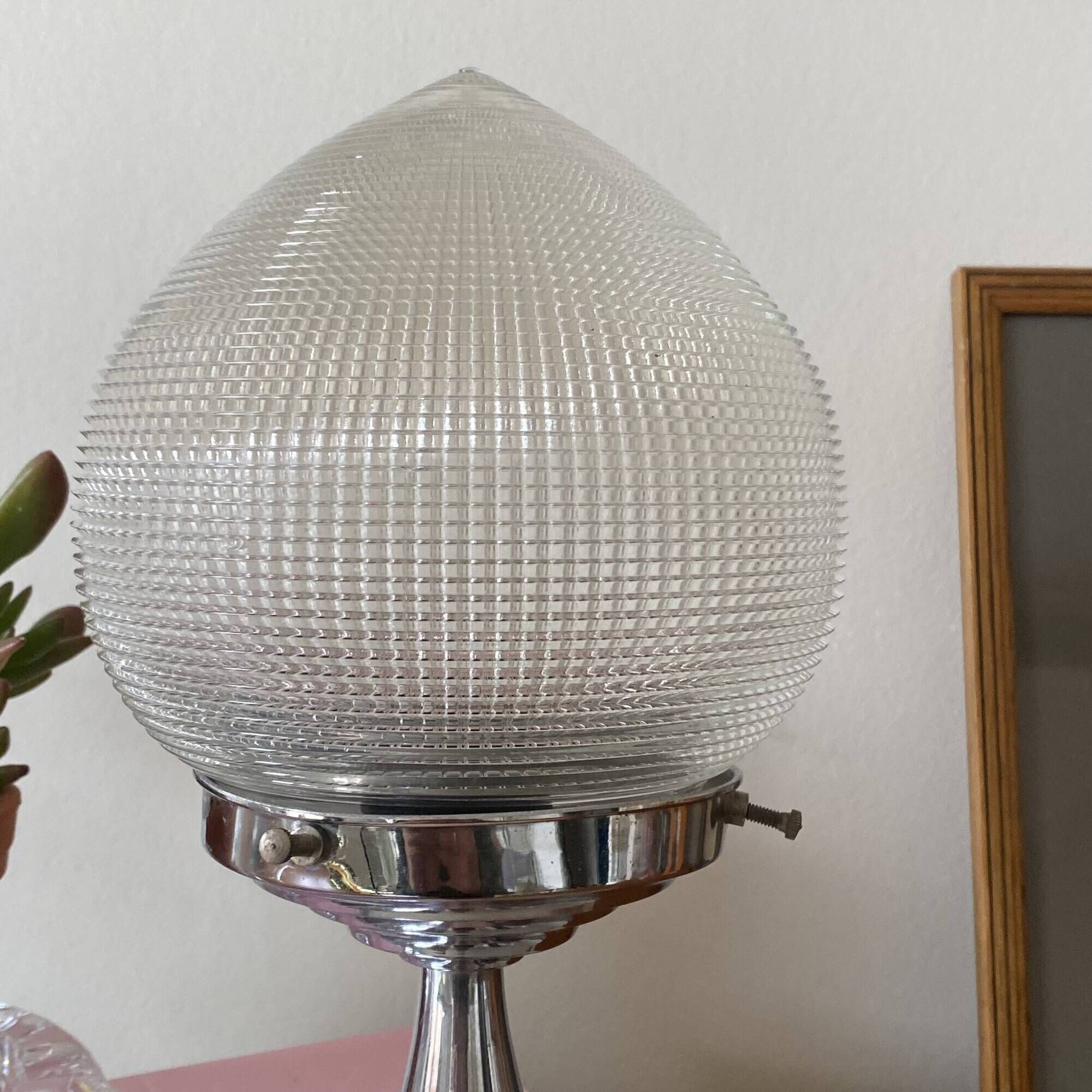 Antique lamp with a glass globe in Holophane style and chrome metal.