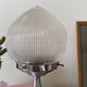 Antique lamp with a glass globe in Holophane style and chrome metal.