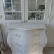 Curved patinated chest of drawers pearl grey waxed finish