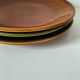 Set of green and amber enamelled plates