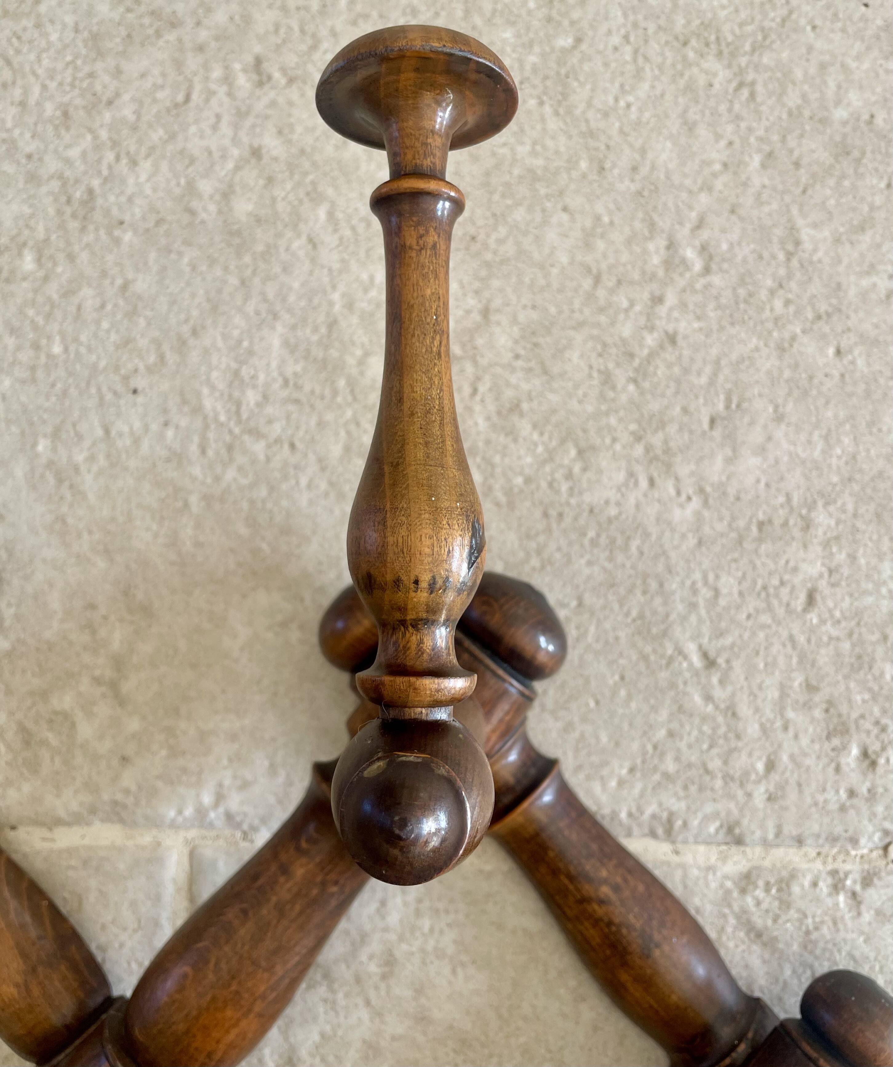 Wall-mounted accordion coat rack made of turned wood