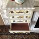 Vintage commode refurbished with 4 drawers in classic style with floral decor.