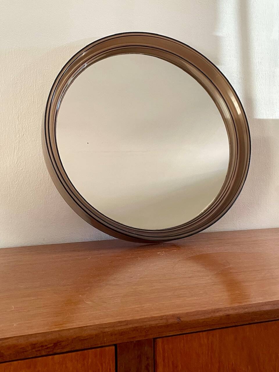 Vintage round smoked plastic mirror, circa 1970s.