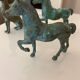bronze statues of horses and dogs
