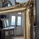 Restoration period mirror in gilded wood from the Napoleonic III era, 165 cm x 130 cm.