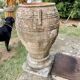 Large Cretan jar in terracotta with three handles on a stone base.