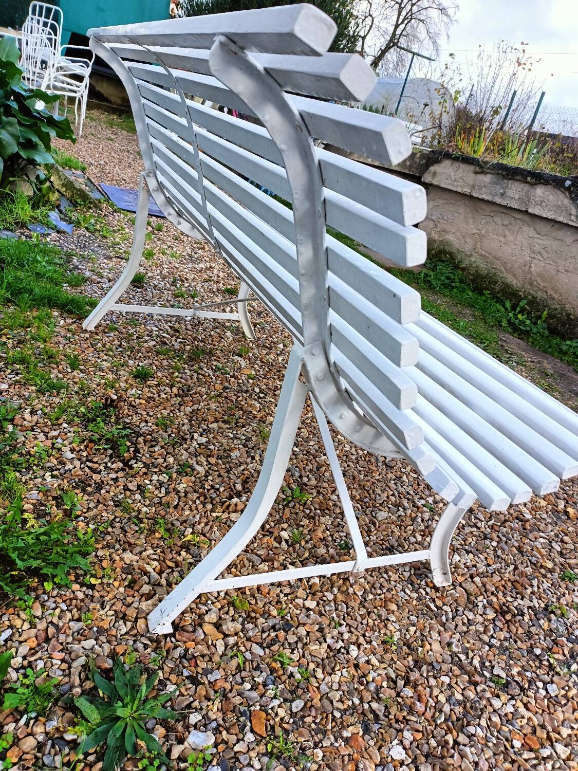 Old garden bench with metal legs and wooden slats