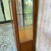 Louis XV style display cabinet in cherry wood with a mirrored back and glass shelves.