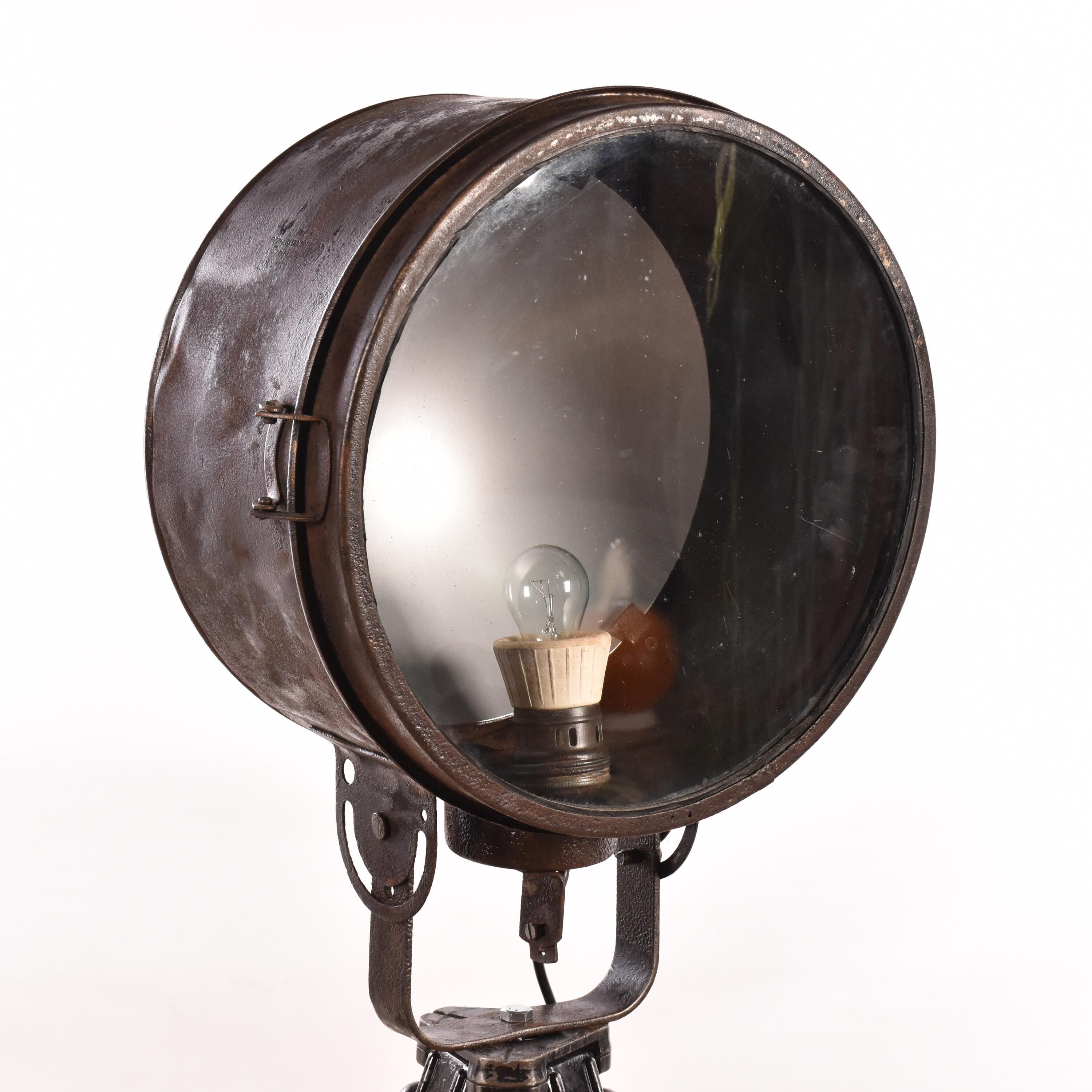 Old industrial spot on wooden tripod floor lamp