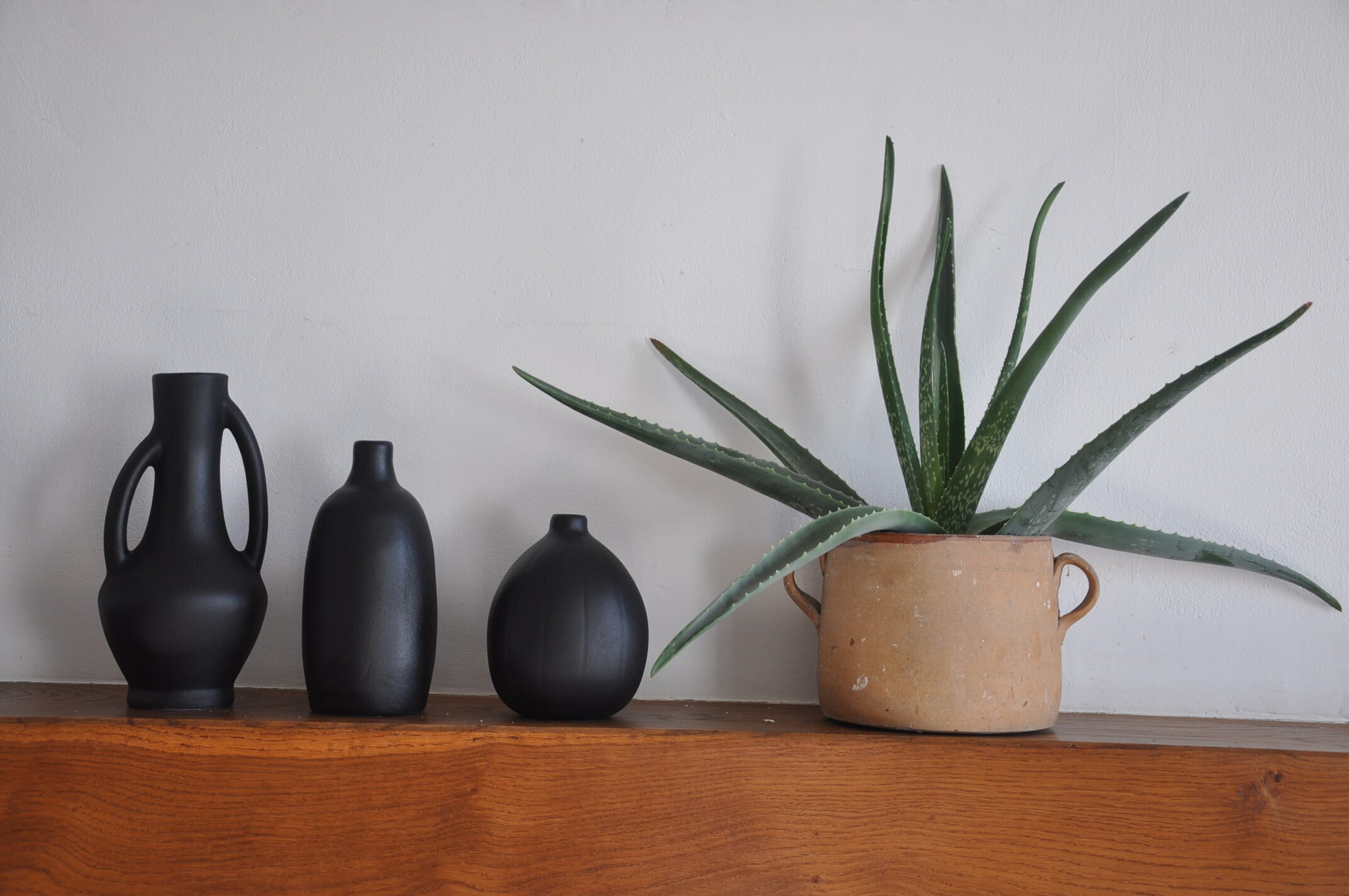 Trio of vintage black vases