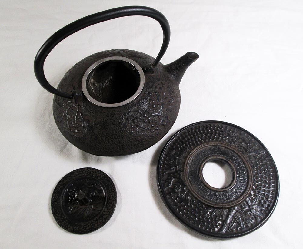 Antique cast iron teapot decorated