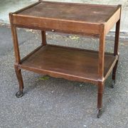 Extendable wooden bar trolley with a glass top from the 1930s.