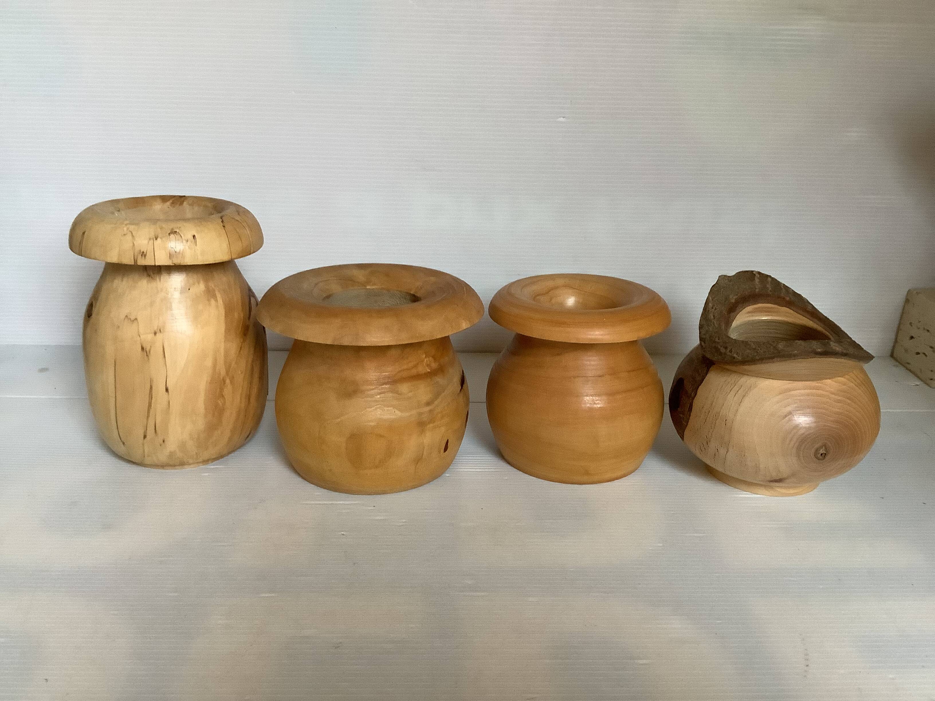 Four solid turned wooden vases
