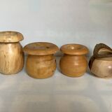 Four solid turned wooden vases