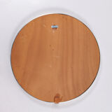 Round mirror covered with leather and chrome, made in France in the 1970s.