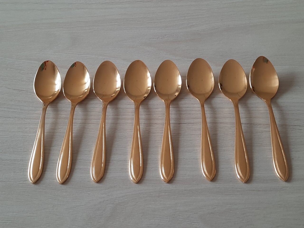 Small golden metal spoons