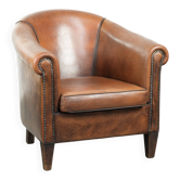 Sheepskin club armchair with beautiful patina and finish with black piping