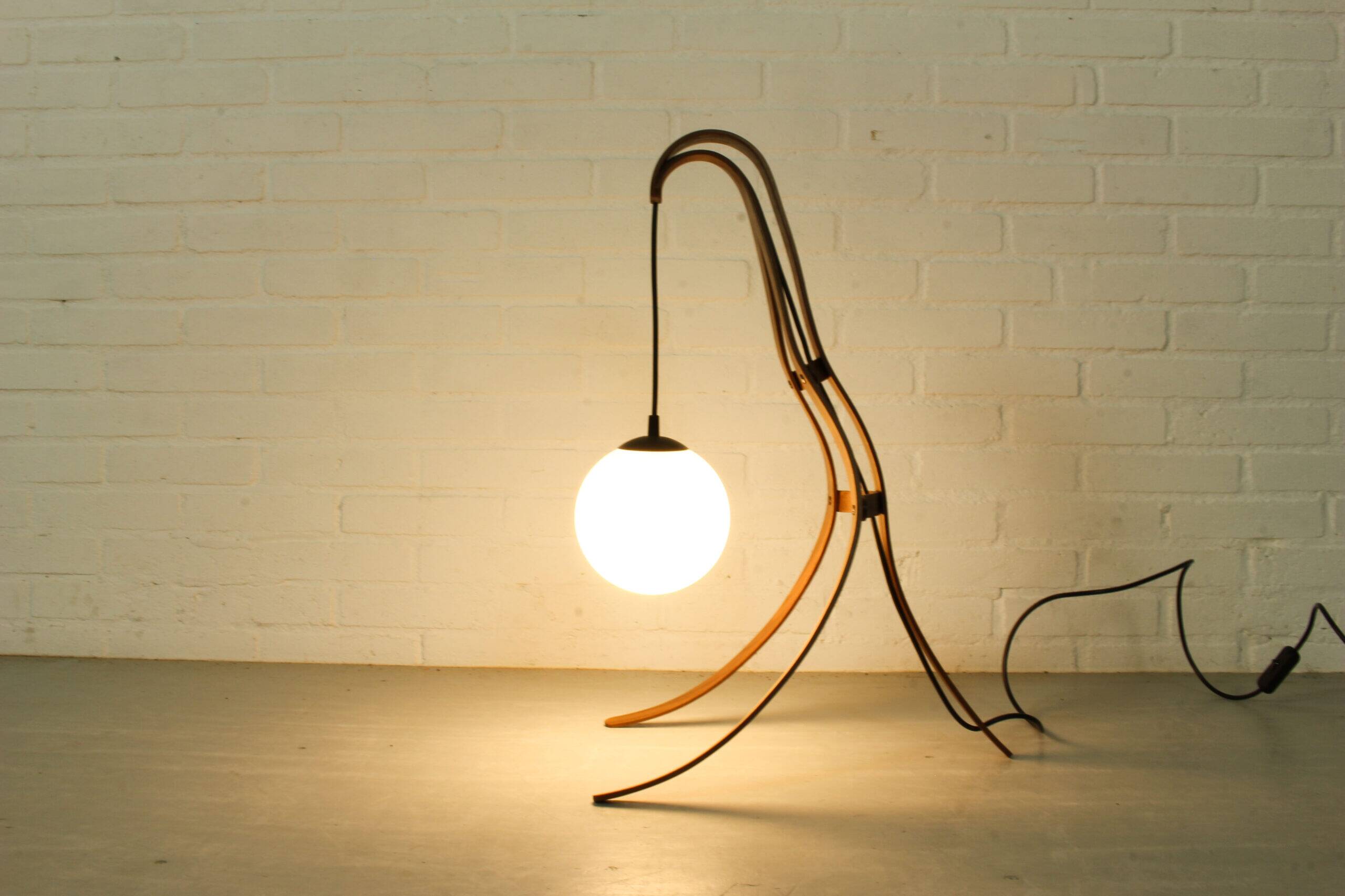 Sculptural table lamp with globe