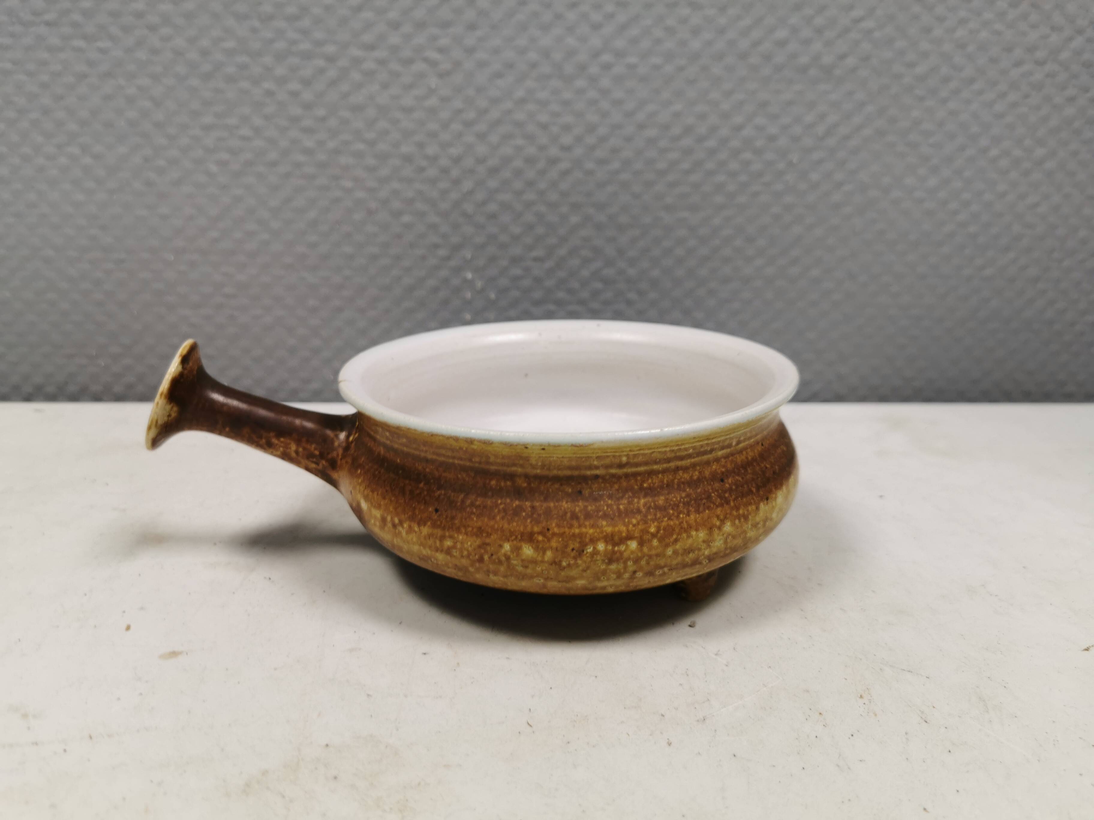 Small ceramic bowl with handle, in golden colours. Danish 1960-70s