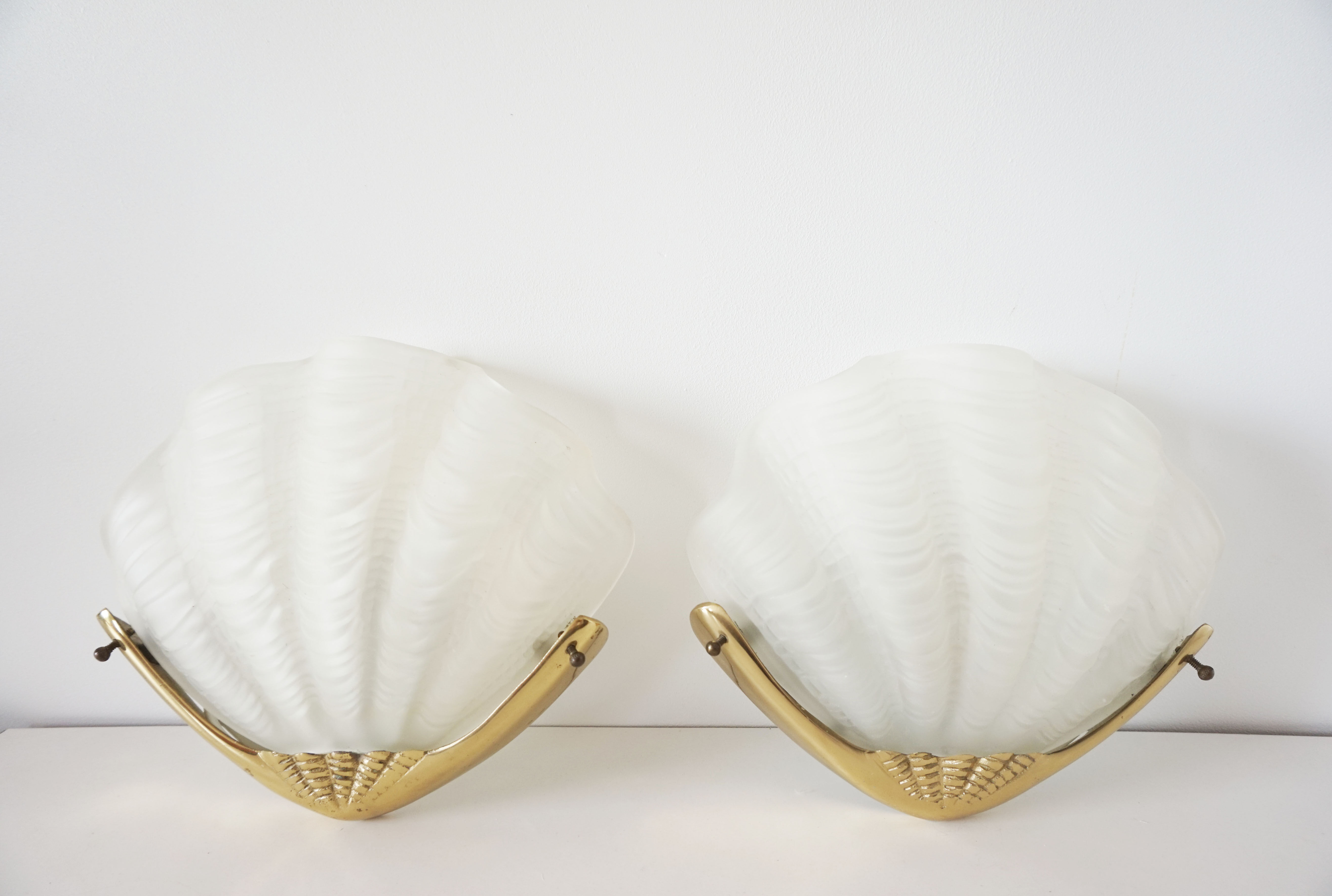 Pair of glass and gold metal shell sconces