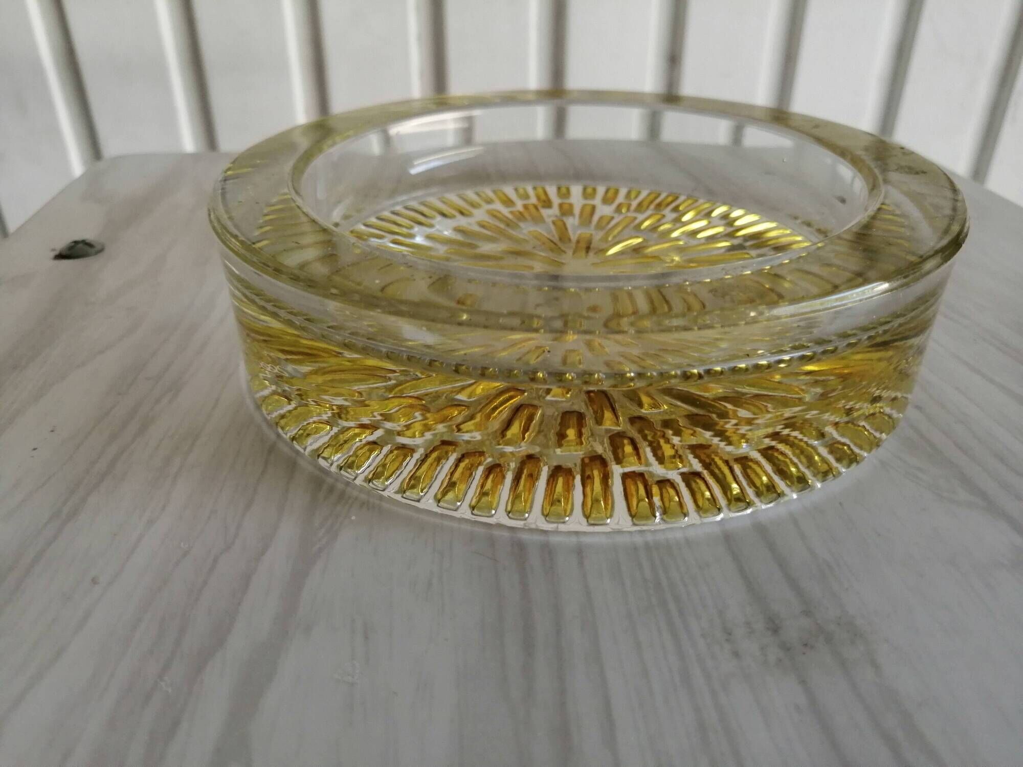 Empty round pockets of iridescent transparent glass of yellow sticks