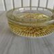 Empty round pockets of iridescent transparent glass of yellow sticks