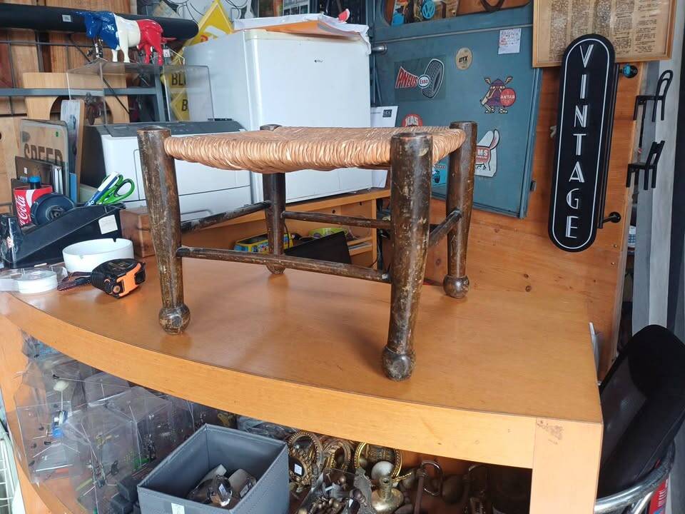 Small rustic vintage stool in wood and straw.