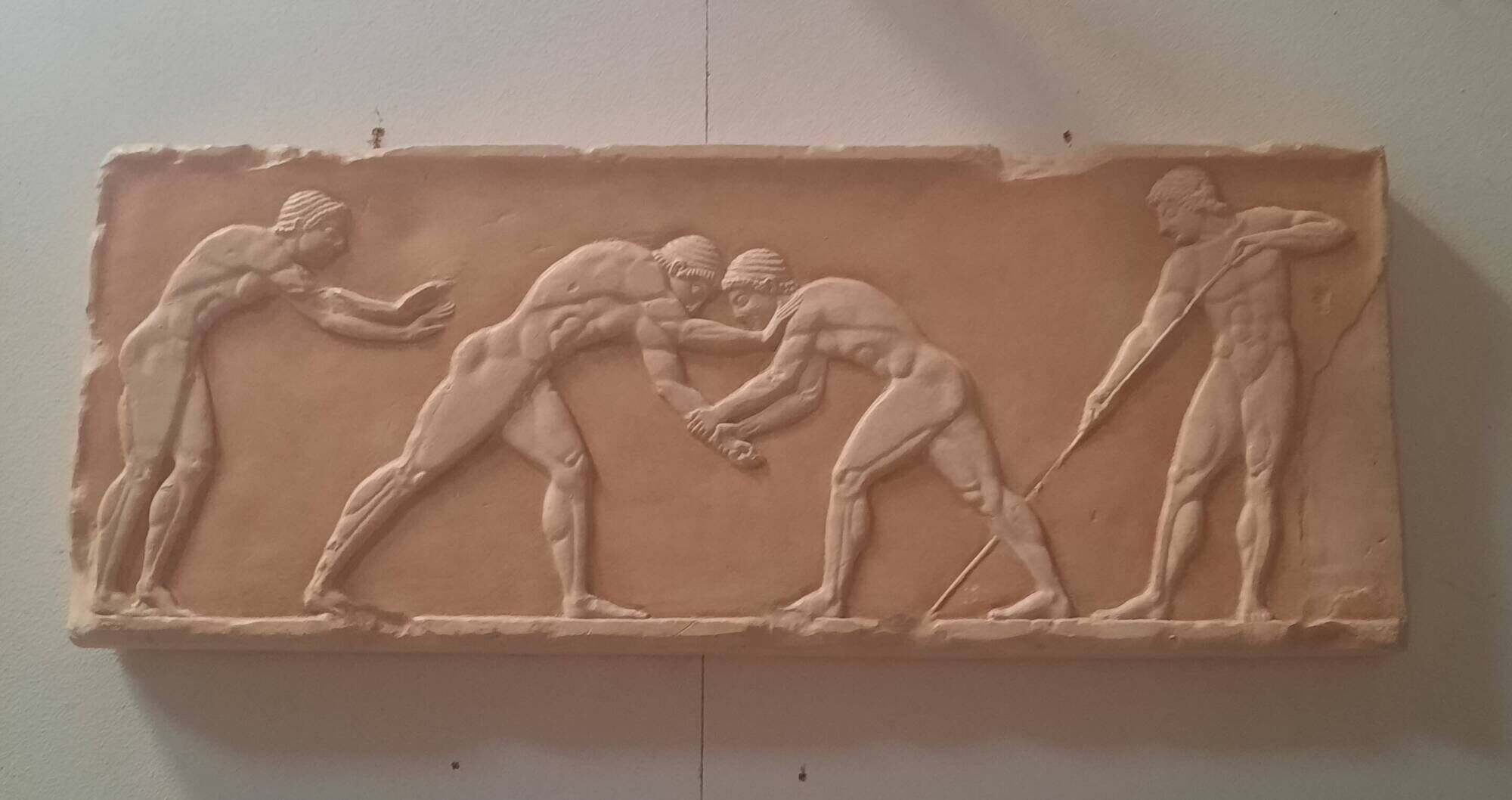 Bas-relief in the antique style featuring athletes.