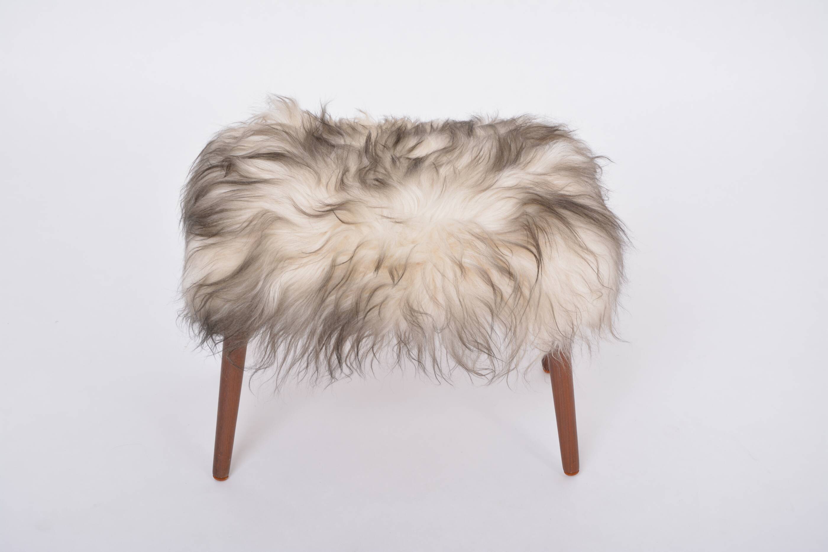 Danish Mid-century Modern stool reupholstered in white and black sheep skin