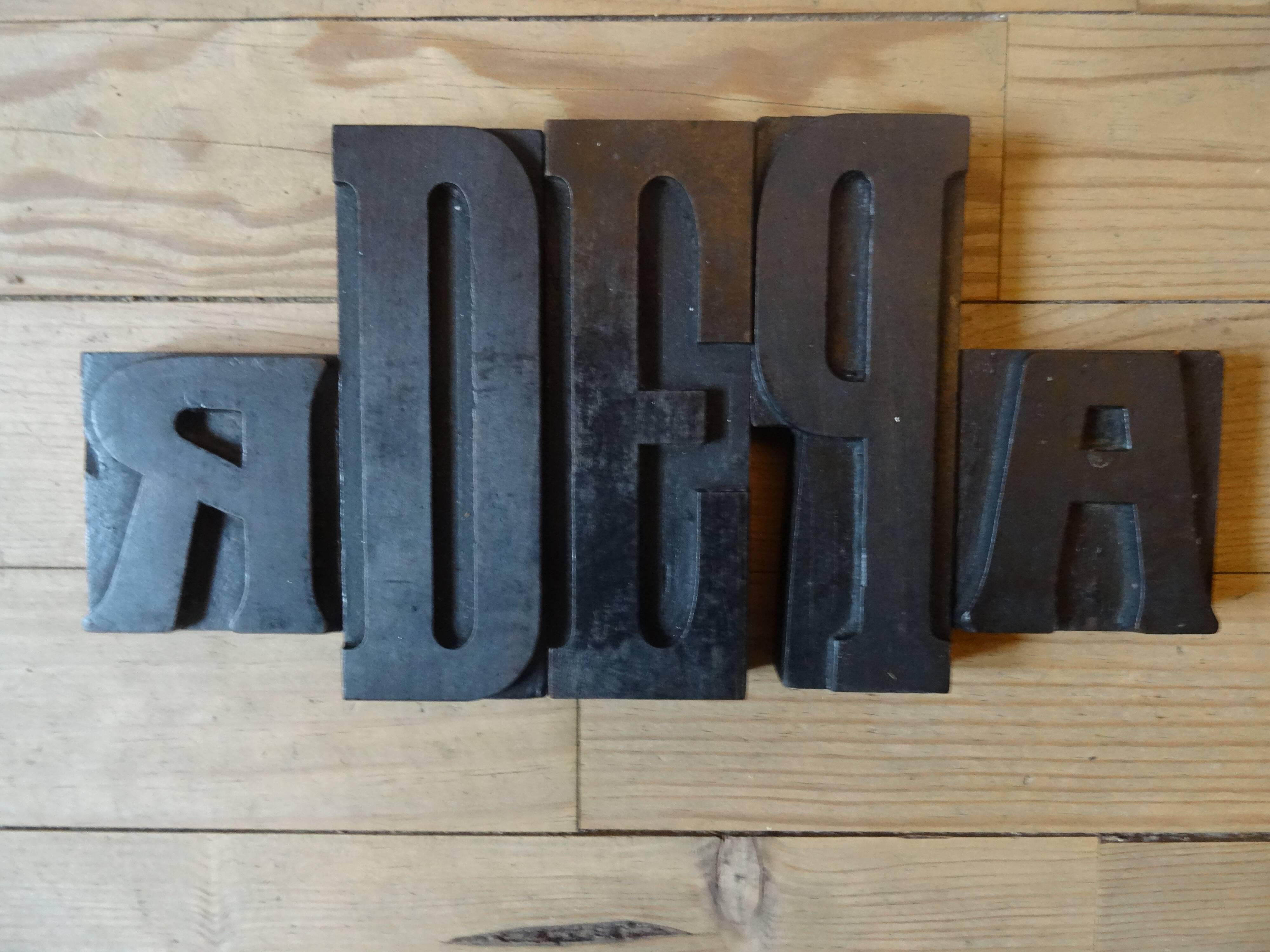 3 wooden printing letters