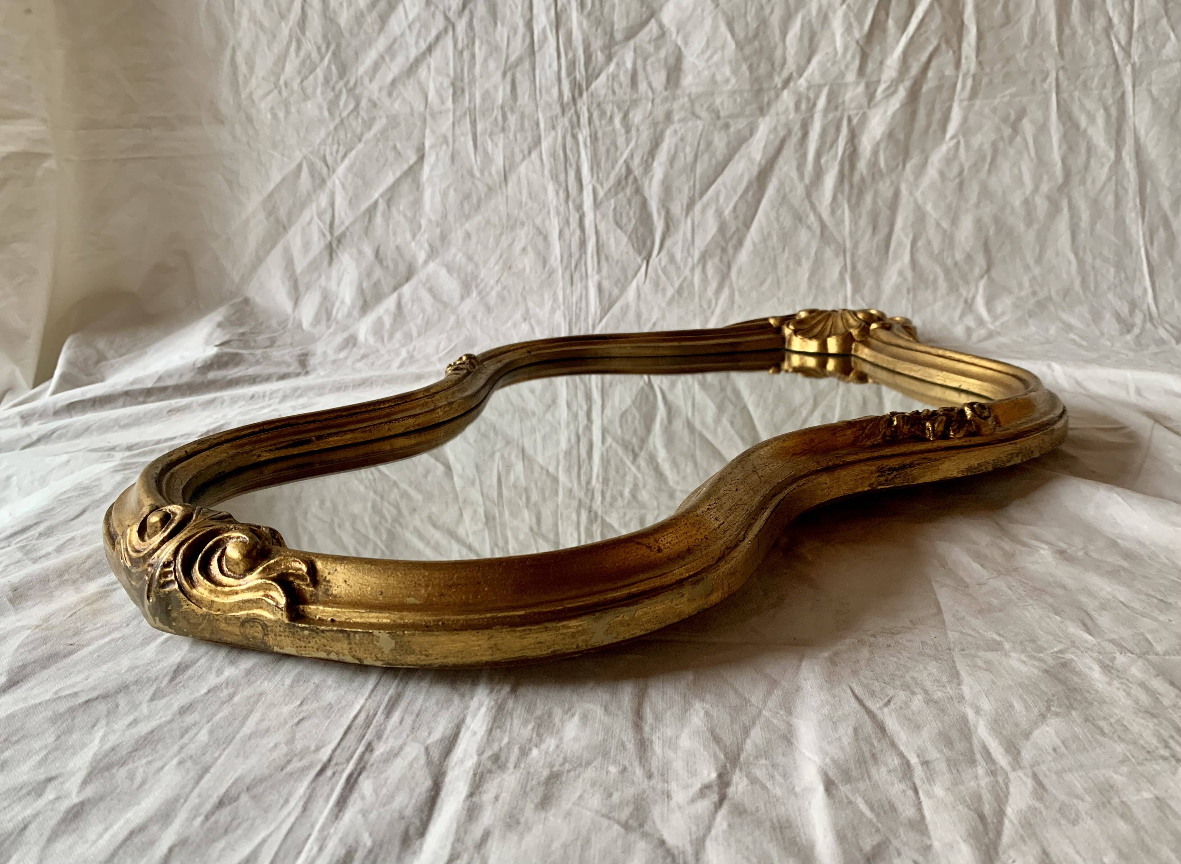 Large rococo mirror in gilded wood