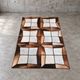 Tapis en patchwork de cuir de vache à lacets / années 1980
