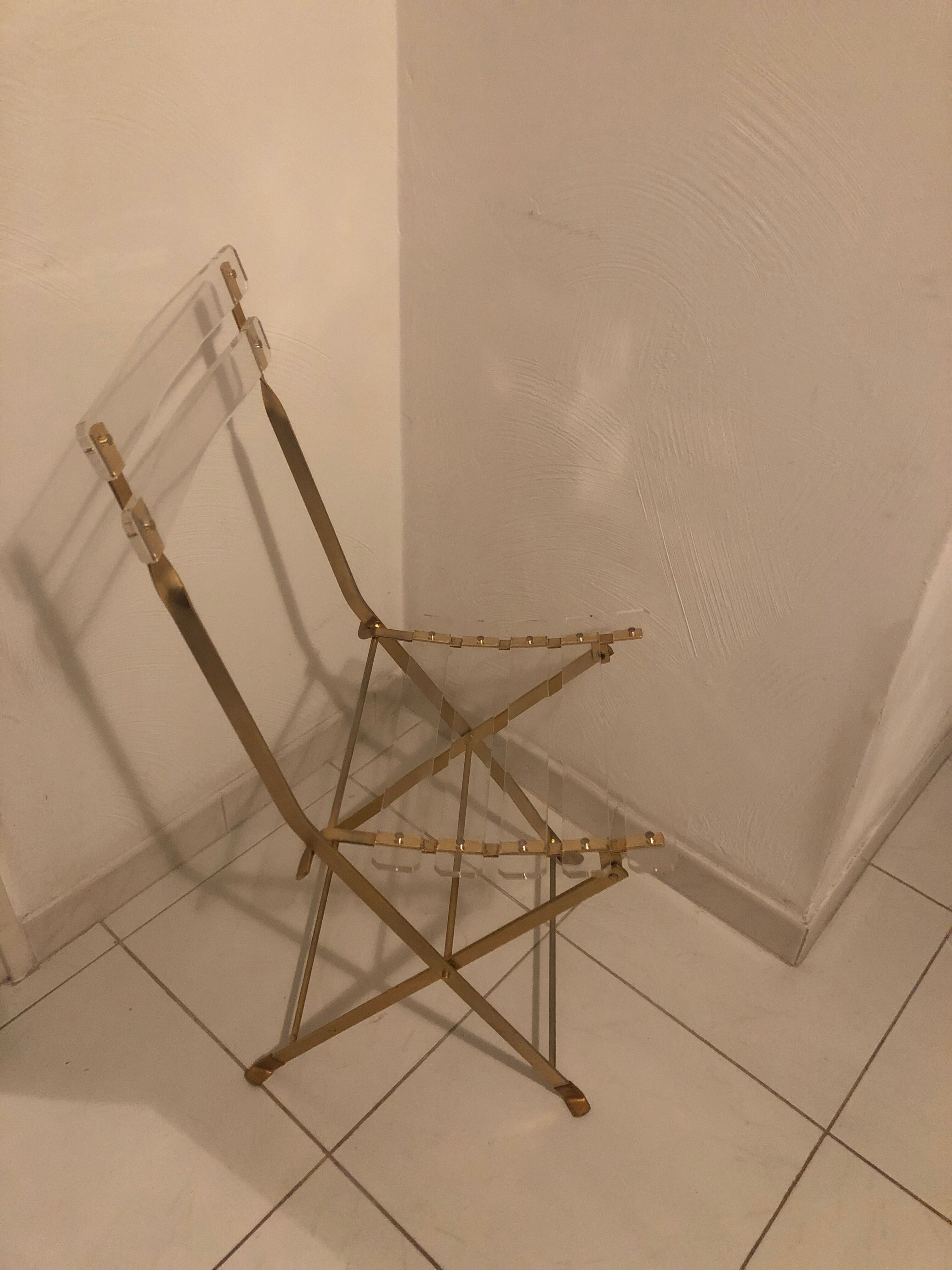 Folding chair in plexiglass and brass