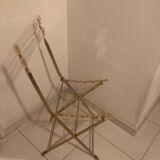 Folding chair in plexiglass and brass