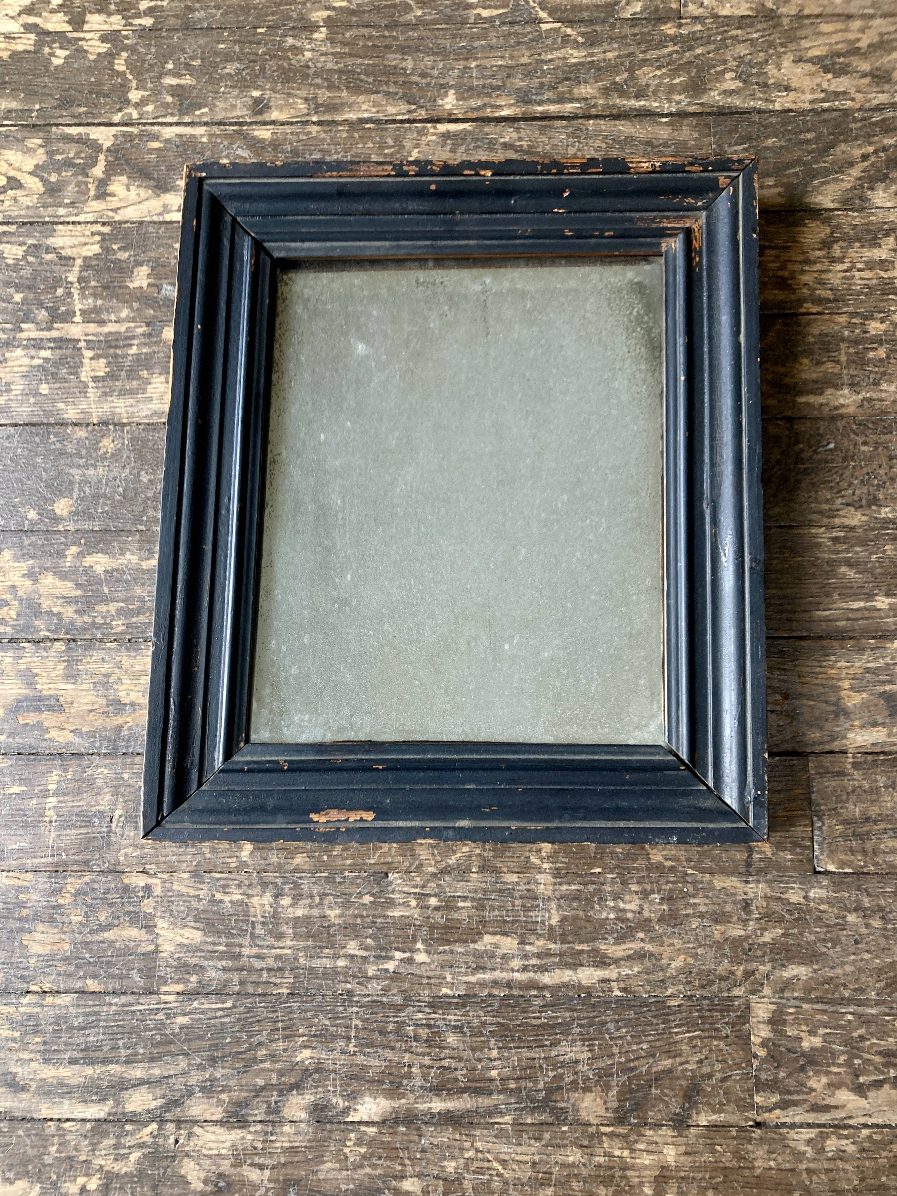 19th century blackened mirror with pitted glass 34cm x 40cm