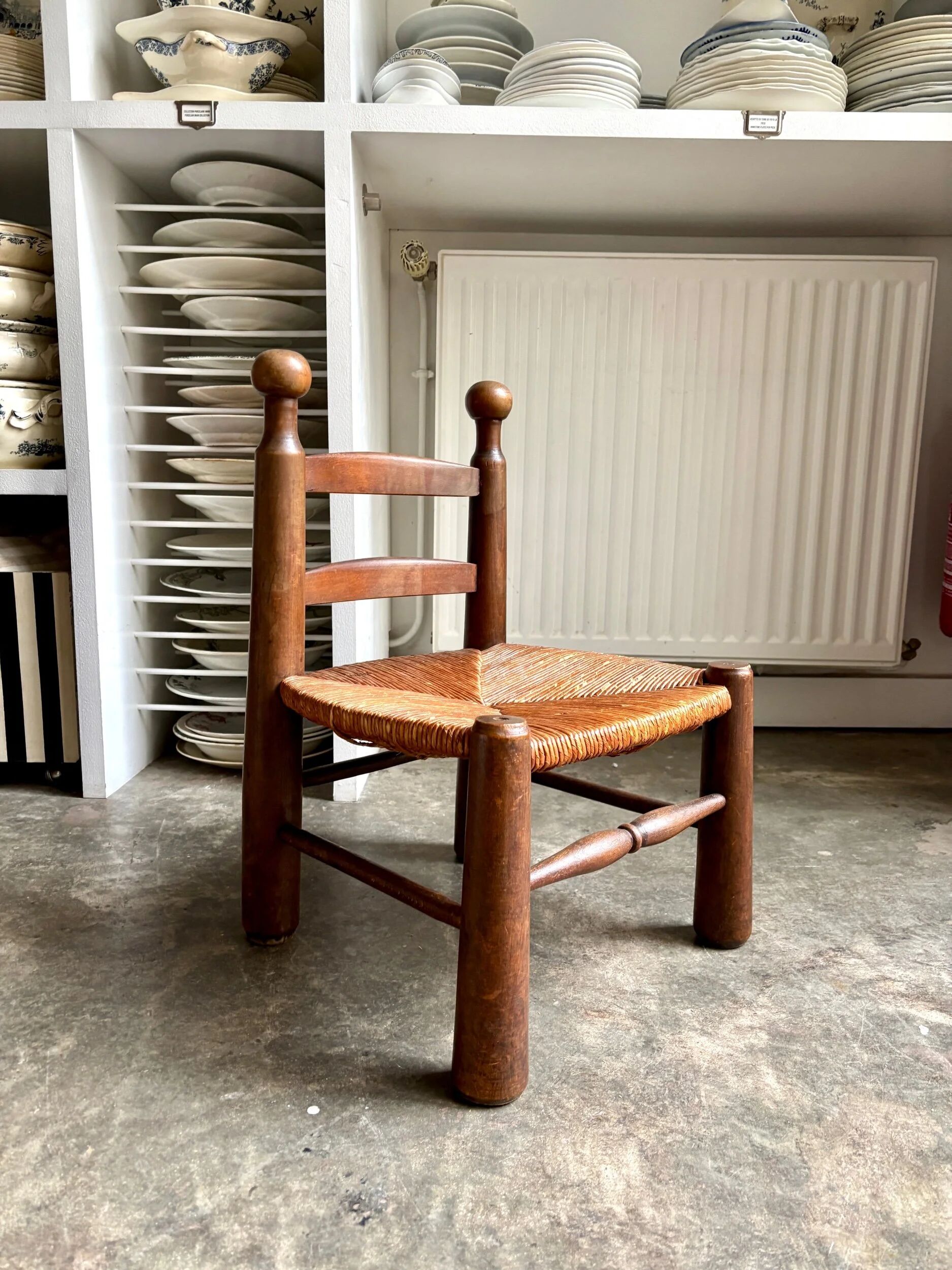 Brutalist low chair in dark wood and straw no. 2