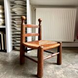 Brutalist low chair in dark wood and straw no. 2