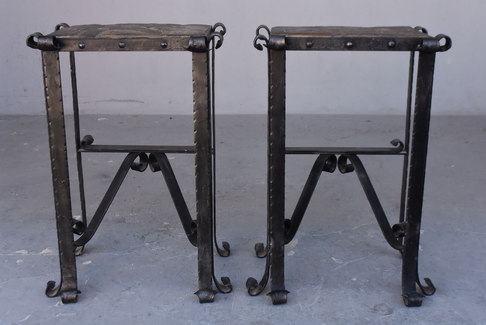 Pair of wrought iron and lava stone bedsides