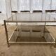 Square brass coffee table and smoked glasses