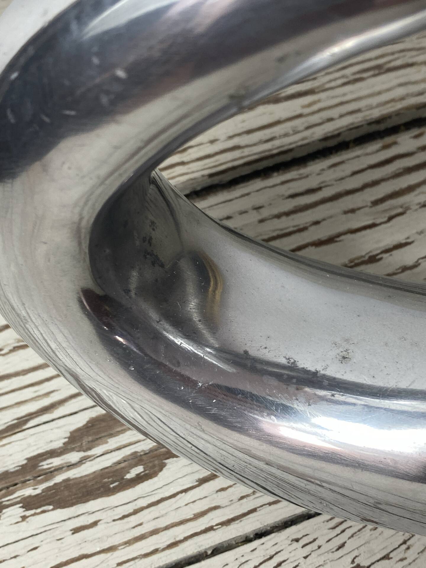 Sculptural vase design in polished aluminium.