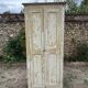Small antique wardrobe with a faded white patina.