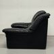 Vintage black leather lounge chair — low postmodern club chair from the space age.