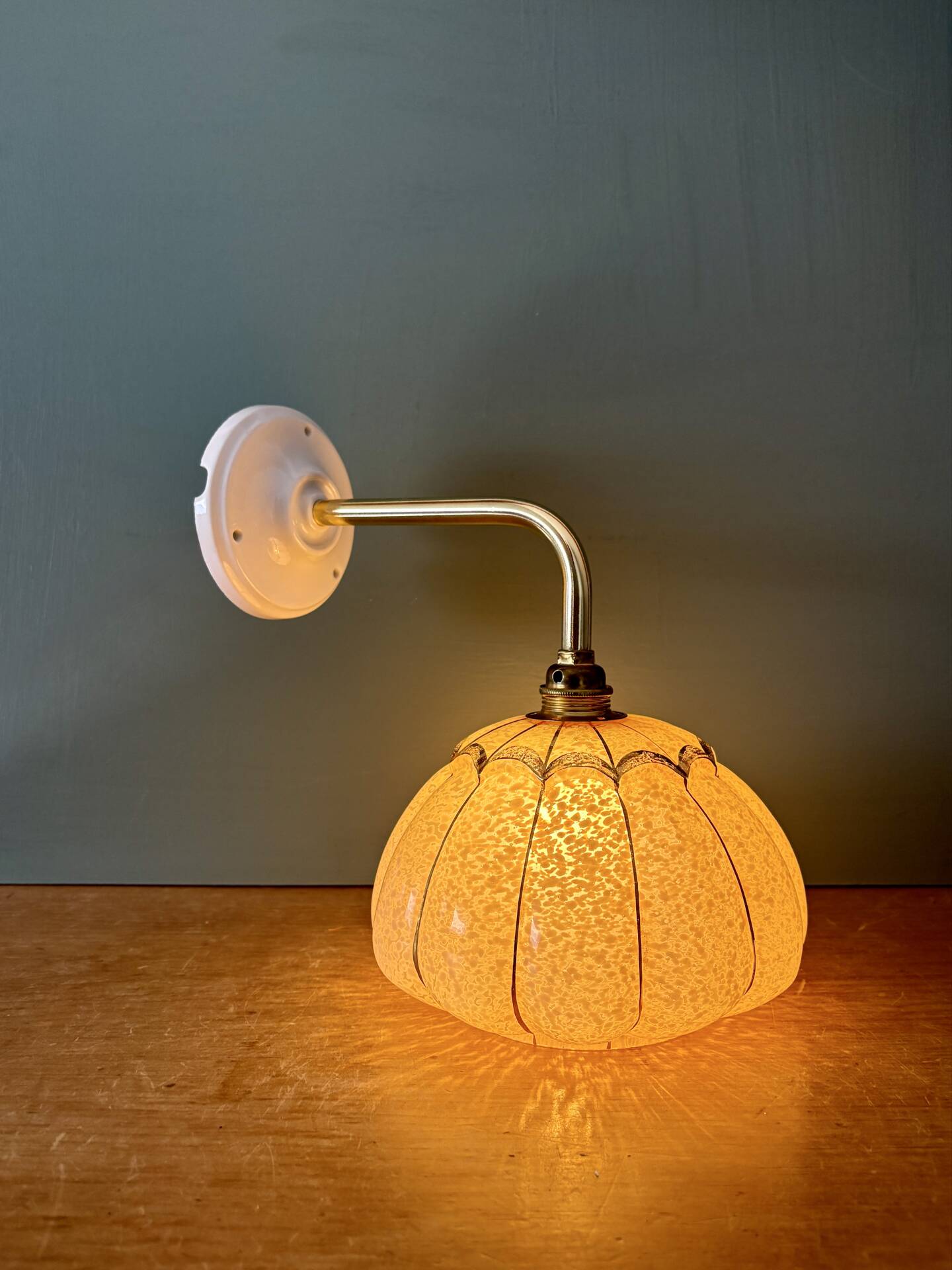 Vintage glass wall light with a pink and gold Clichy globe.