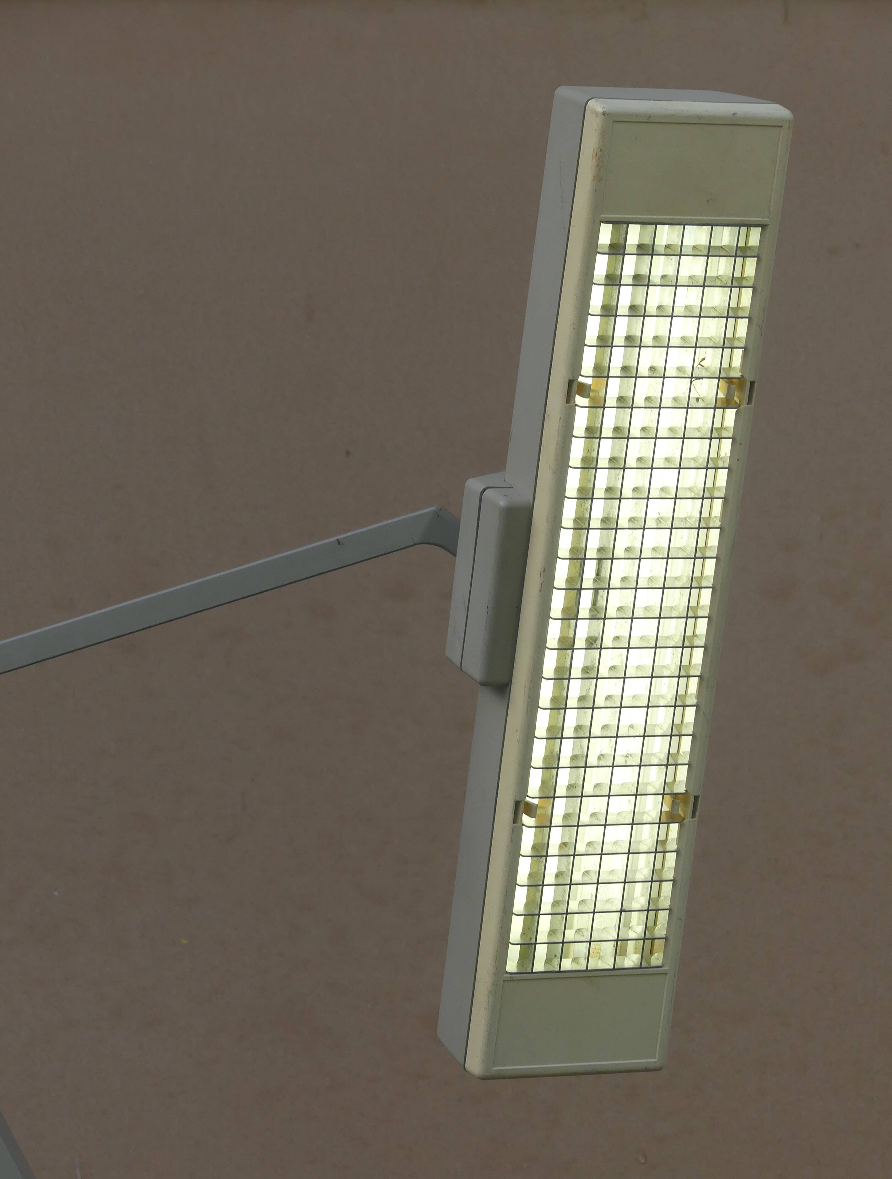 WALDMANN articulated workshop lamp with two industrial clamp arms for architects.